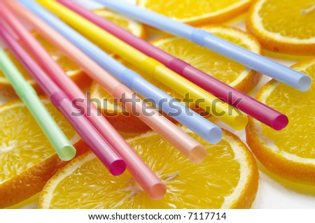 Straw on juicy citrus slices