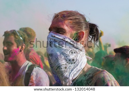 LOS ANGELES - MARCH 16 : Celebrant with bandana covering nose and mouth to protect from inhaling the color powder in the air. Holi Festival of Colors on March 16, 2013 in Los Angeles, CA