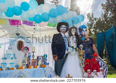 Los Angeles, CA - November 1, 2014:  Unknown people and altar on display at the 15th annual Day of the Dead Festival (Dia de los Muertos) at the Hollywood Forever Cemetary in Los Angeles, CA.
