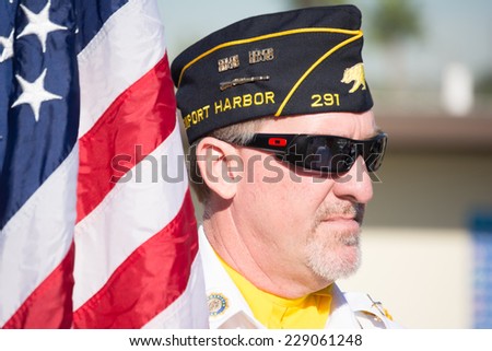 San Pedro, CA - November 8: An unidentified  veteran with American flag at the Veterans Week in Port of Los Angeles in San Pedro, CA on November 8, 2014