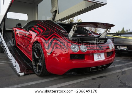 Woodland Hills, CA - December 7, 2014:  Bugatti Veyron entering enclosed auto transport at the 11th Annual Motor4toys Charity Car Show and Toy Drive