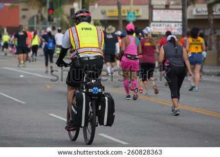Los Angeles, California, USA - March 15, 2015: Unidentified firefighter in bicycle participating in the 30th LA Marathon Edition