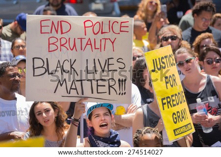 Los Angeles, CA, USA - May 02, 2015: Woman holding sign during march against the death of Freddie Gray, a man of Baltimore who was seriously injured in police custody.