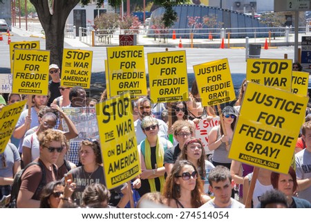 Los Angeles, CA, USA - May 02, 2015: Group of people holding signs during march against the death of Freddie Gray, a man of Baltimore who was seriously injured in police custody.