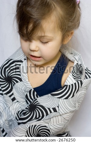 photo of little girl playing with too big clothes