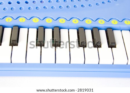 blue child\'s piano isolated on white