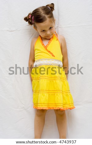 little, cute girl wearing yellow summer dress