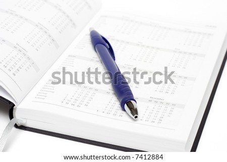 open calendar with blue pen isolated on white