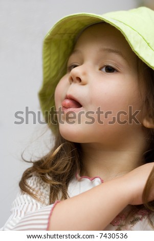 stock photo : Little cute girl with long hair wearing a hat