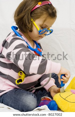 little doctor. 4 years old girl playing with stethoscope