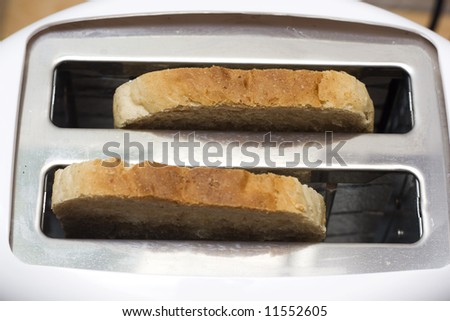 white toaster with toasts in the kitchen