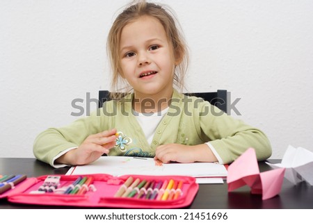 cute little girl drawing a picture on white