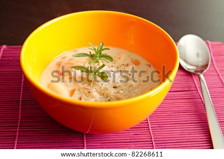 fresh lentil soup in an orange bowl