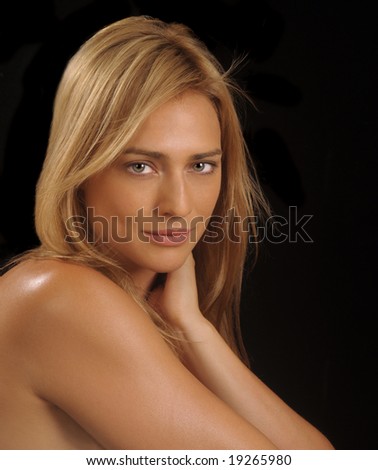 Glamor portrait of a woman looking over her shoulder on black