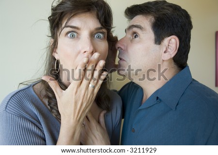 Man whispers in her ear and she is surprised