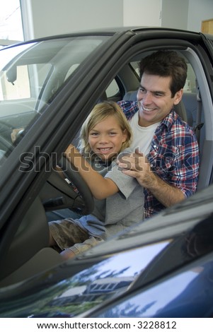 Father and son in drivers seat of car