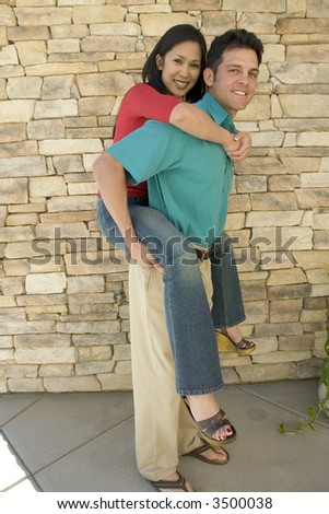 Man gives woman a piggy-back ride