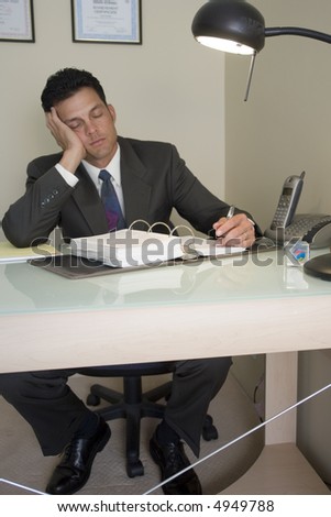 Portrait of a business man bored at his work desk