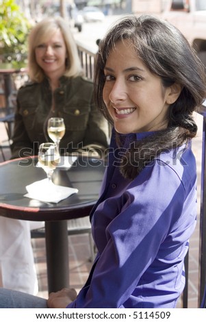 Two woman enjoying drinks outside