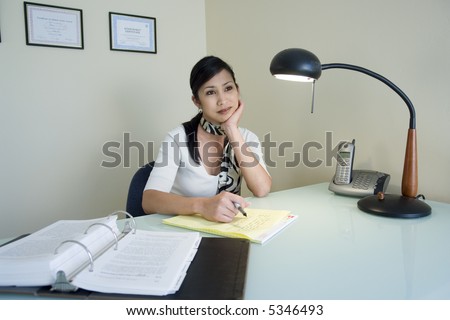 Portrait of a woman acting bored at her work desk