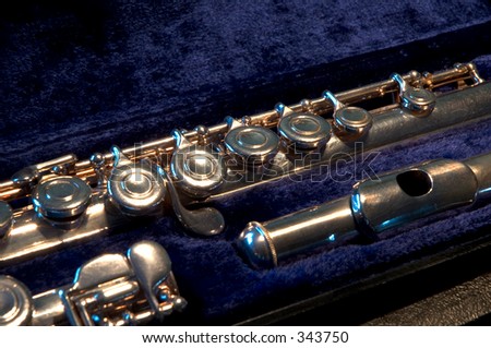 Close up of a transverse flute on its case featuring the keys