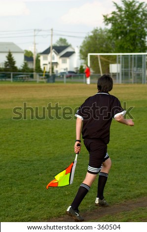 Soccer referee with flag team