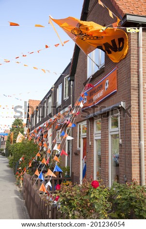 AMERSFOORT, NETHERLANDS, JUNE 22 2014: orange flags along lines against houses in the dutch town of Amersfoort