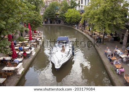 UTRECHT, NETHERLANDS, JUNE 27 2014: boat and people eating outside in old centre of dutch town utrecht