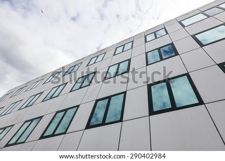 modern facade of university office buildings and reflections of clouds in windows