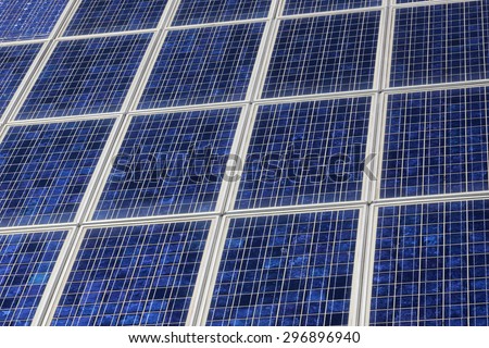 closeup of a chess board pattern of solar panels close together