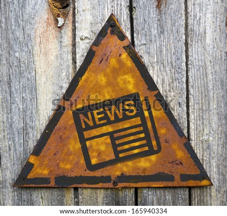 News - Newspaper Icon on Weathered Triangular Yellow Warning Sign. Mass Media Concept.