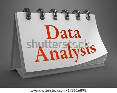 Data Analysis - Red Words on White Desktop Calendar Isolated on Gray Background.