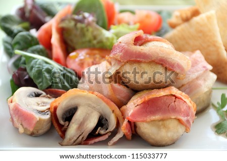 Delicious whole mushrooms wrapped in bacon strips ready to serve.