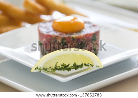 Lemon and mint with steak tartare raw egg and fried bread strips ready to serve.