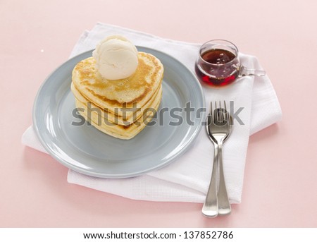 Delightful heart shaped pancakes served with vanilla ice cream and maple syrup.