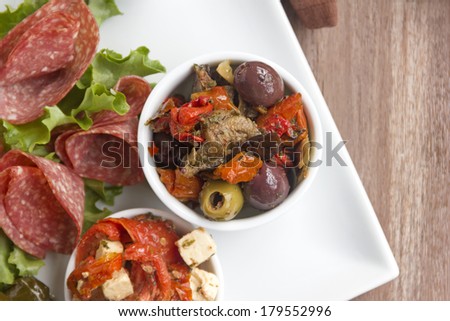 Delicious black olives and stuffed green olives with sundried tomato on a antipasto platter.