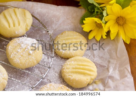 Fresh baked melting moments shortbread biscuits with icing sugar straight from the oven.