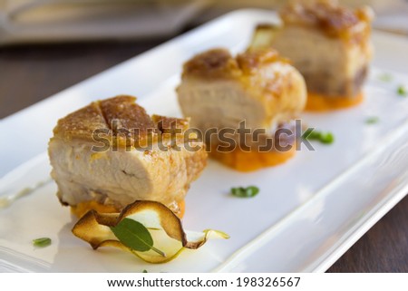 Delicious roasted pork belly cubes on baked pumpkin with fried apple chips and a cauliflower puree with organo and sage.
