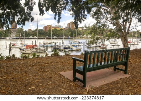 Boats and yachts moored in the Brisbane River by the Brisbane City Botanical Gardens in Queensland Australia.