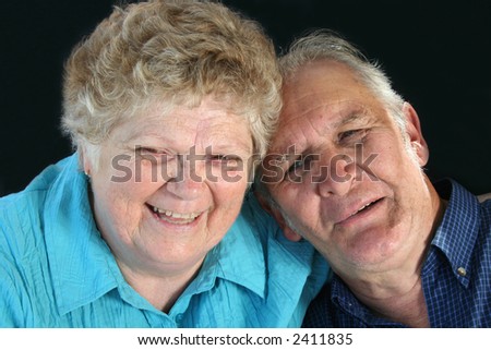 Happy senior couple enjoy a laugh.