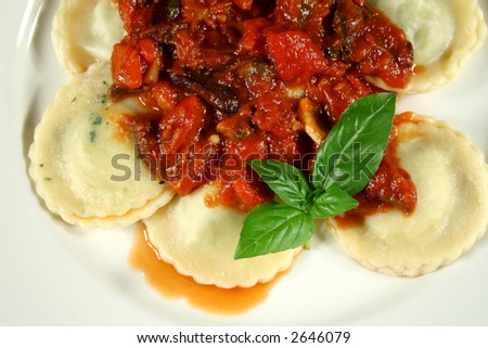 Chicken and spinach ravioli with a capsicum, olive and tomato sauce.