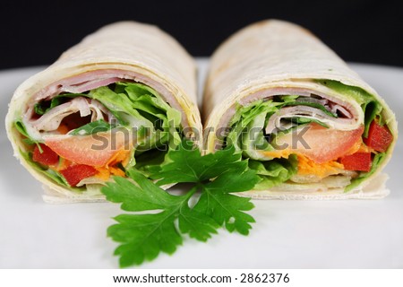Delicious cut ham and salad wrap ready to serve.