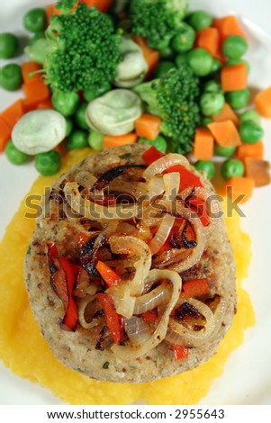 Chicken patty on a bed of pumpkin with fresh steamed vegetables.