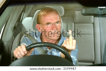 Middle aged man gives rude sign in road rage incident.