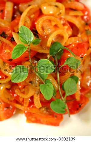 Warm salad consisting of cherry tomatoes and caramelized onion with oregano.
