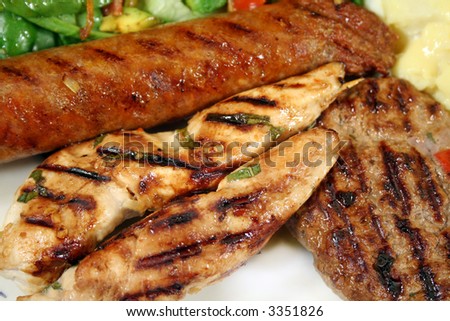 BBQ chicken tenderloin skewers, beef sausage, beef patty with spinach salad and potato salad.