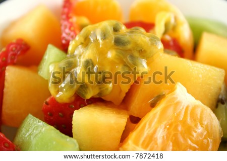 Delicious bowl of freshly picked fruit salad topped with passionfruit.
