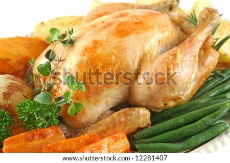 Whole roast chicken with potatoes pumpkin carrots and beans.