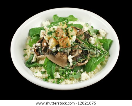 Mushrooms with ricotta cheese on couscous with herb croutons and rocket salad.