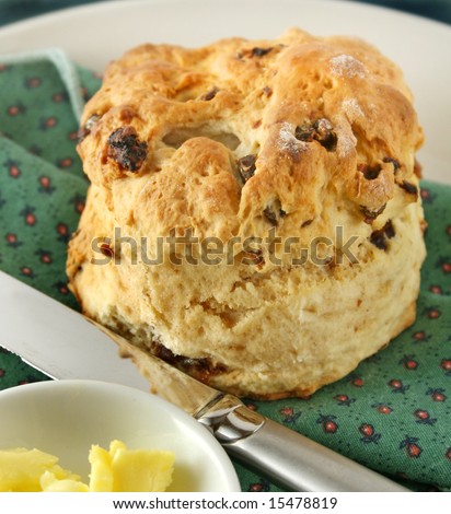 Fresh baked date scone with butter curls ready to serve.